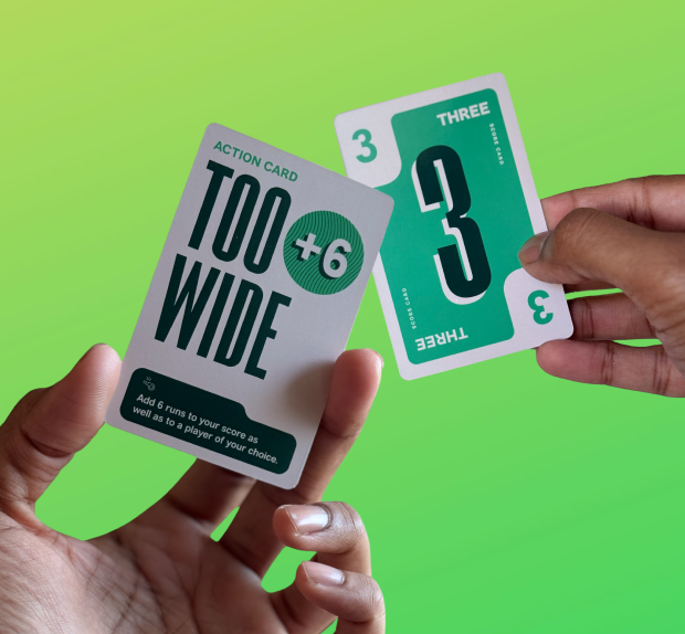 Two hands holding a Too Wide action card and a Three score card